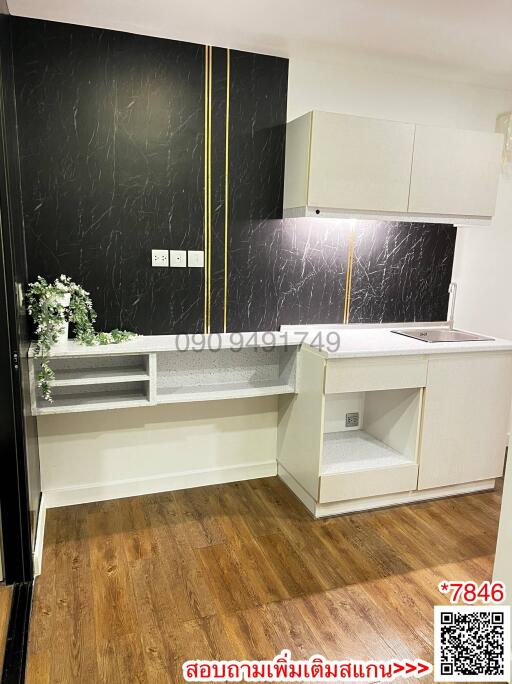 Modern kitchen with black marble walls and wooden floor