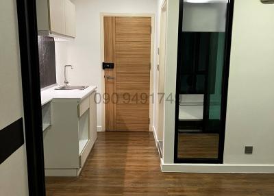 Modern kitchen with wooden flooring and white cabinets