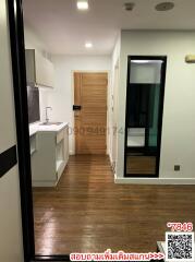 Modern kitchen with wooden flooring and white cabinets