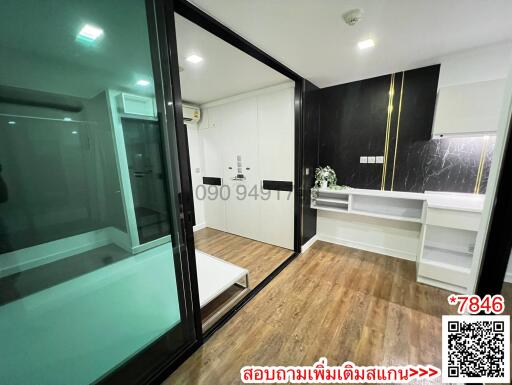 Modern apartment interior with open sliding glass door and fully equipped kitchen