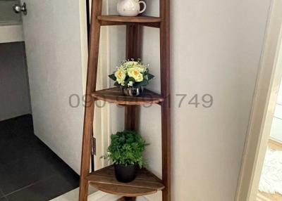 Elegant entryway with decorative shelving and wood flooring