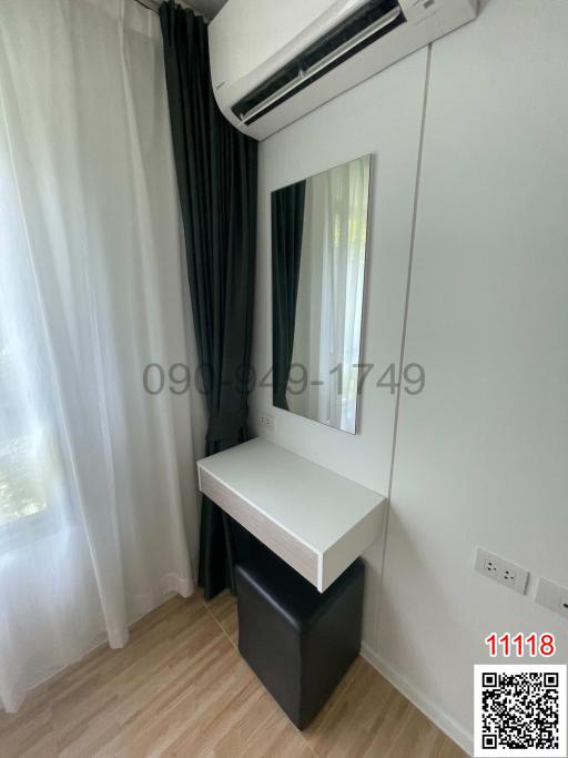 Cozy bedroom with air conditioning unit and large window with curtains
