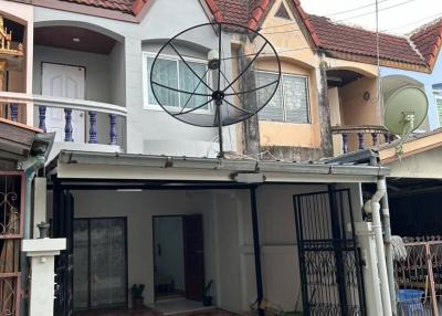 Two-story residential house front view with satellite dish