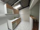 Compact modern kitchen with terrazzo flooring and wooden accents