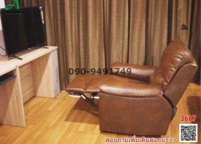 Cozy living room with brown recliner chair and a television set