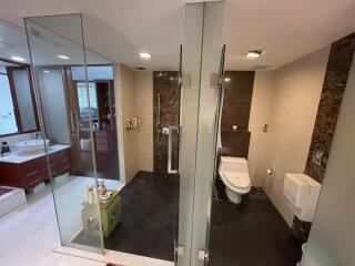 Modern bathroom with glass shower enclosure and dual sink vanity