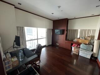 Spacious living room with hardwood floors and packed moving boxes