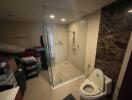 Modern bathroom with glass shower and marble walls