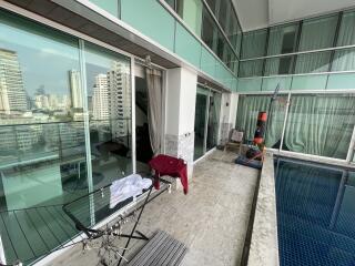 Spacious balcony with city view and a private pool
