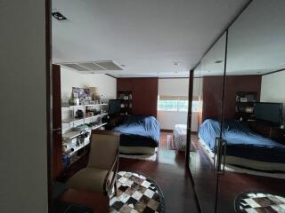 Spacious bedroom with twin beds and ample natural lighting