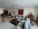 Spacious and elegantly decorated living room with modern furnishings and large art piece