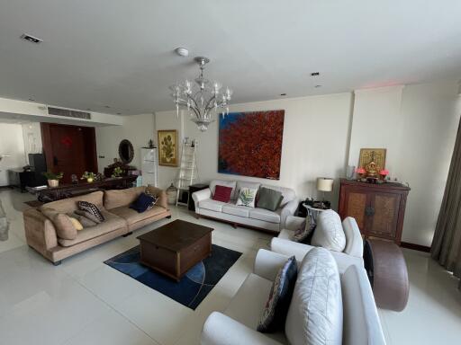 Spacious and elegantly decorated living room with modern furnishings and large art piece