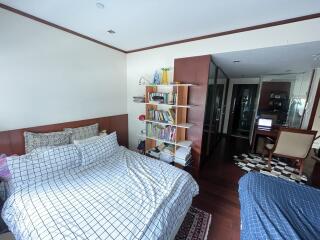 Cozy bedroom with bookshelf and workspace