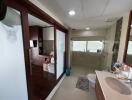 Spacious modern bathroom with glass shower enclosure and dual sink vanity
