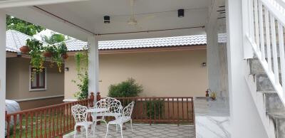 Spacious covered patio area with outdoor seating and tiled floor