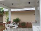 Spacious covered patio area with outdoor seating and tiled floor