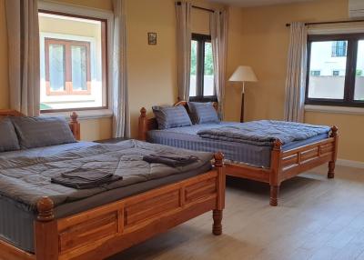 Spacious Bedroom with Two Single Beds and Large Windows