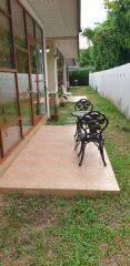 Spacious tiled patio with outdoor furniture by the house