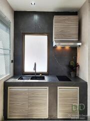 Modern kitchen with black marble walls and wooden cabinets