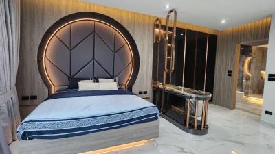 Modern bedroom with large bed and luxurious en suite bathroom