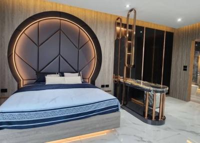 Modern bedroom with large bed and luxurious en suite bathroom