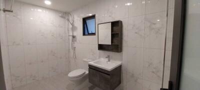 Modern bathroom with white tiles and a shower