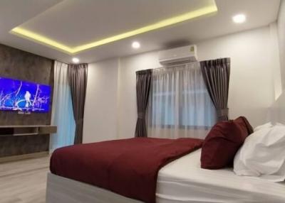 Modern Bedroom with LED TV and Ambient Lighting