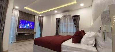 Modern Bedroom with LED TV and Ambient Lighting