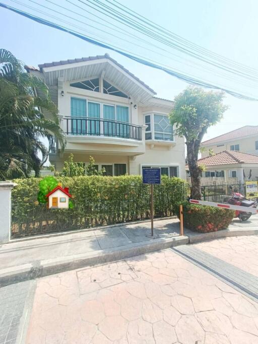 Exterior view of a two-story residential house with a balcony