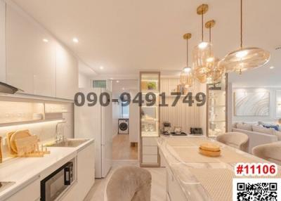 Modern kitchen interior with integrated appliances and elegant pendant lights