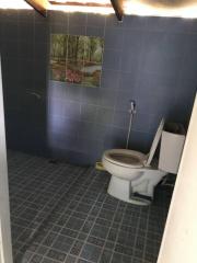 Small bathroom with blue tiles and a wall-mounted painting