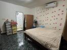 Cozy bedroom with air conditioning and patterned tile flooring