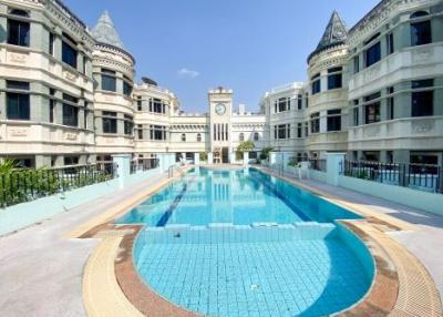 Elegant outdoor swimming pool area with classical architecture
