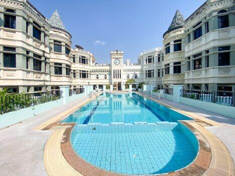 Elegant outdoor swimming pool area with classical architecture