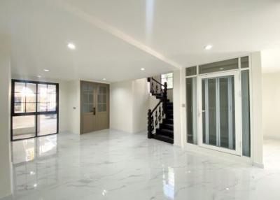 Spacious and well-lit living area with shiny marble flooring