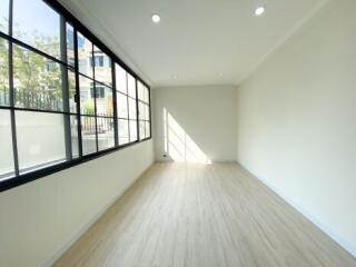 Spacious and well-lit empty living room with large windows