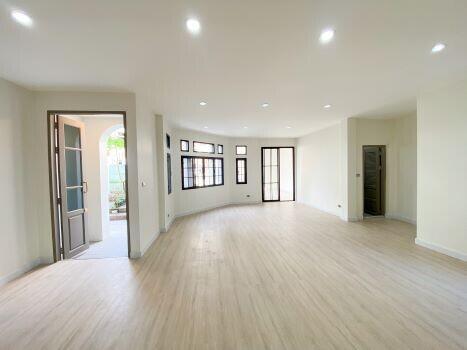 Spacious empty living room with natural light and hardwood floors