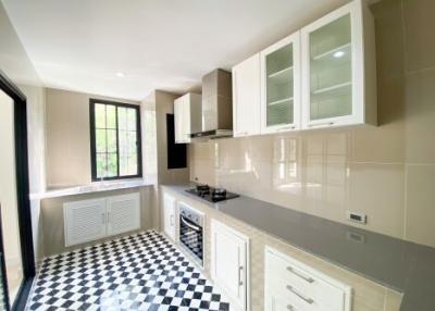 Modern kitchen with checkered floor and white cabinetry