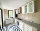 Modern kitchen with checkered floor and white cabinetry