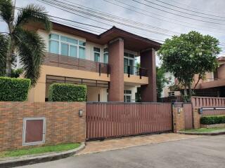 Modern two-story house with brick fence and gate