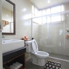 Modern bathroom interior with glass shower and tiled walls