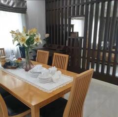 Modern dining room interior with wooden dining table set and decorative partition
