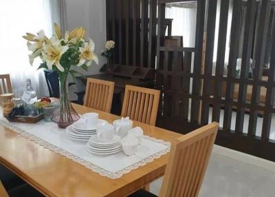 Modern dining room interior with wooden dining table set and decorative partition