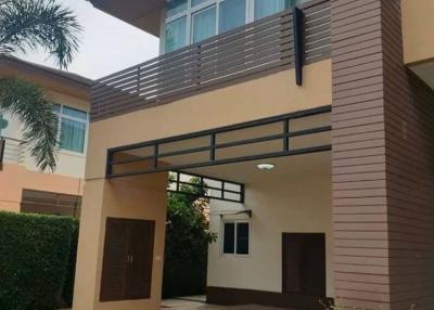 Modern two-story house with a balcony and carport