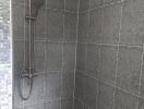 Modern tiled shower with stainless steel fixtures