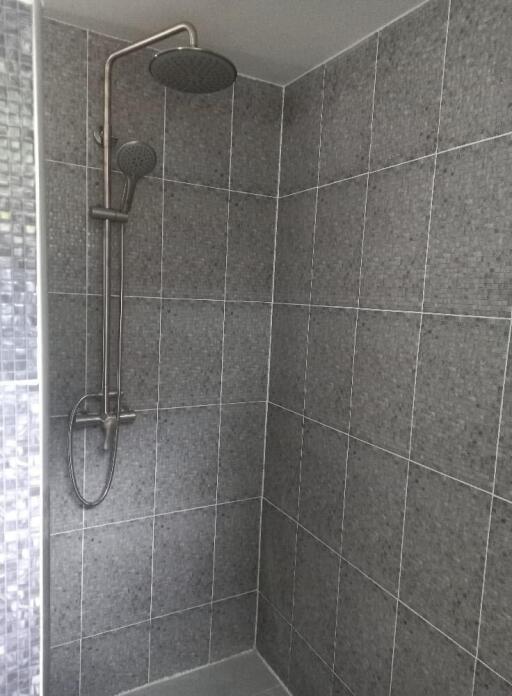 Modern tiled shower with stainless steel fixtures