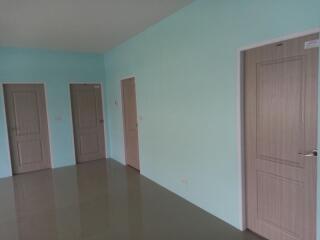 Empty interior space with multiple doors and tiled flooring