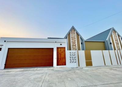 Modern single-family home exterior with large garage door