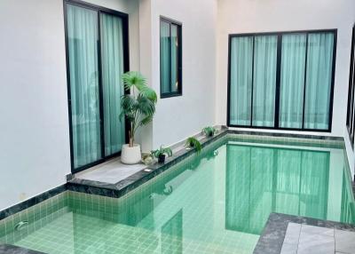 Indoor swimming pool with large windows and natural lighting