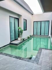 Indoor swimming pool with large windows and natural lighting